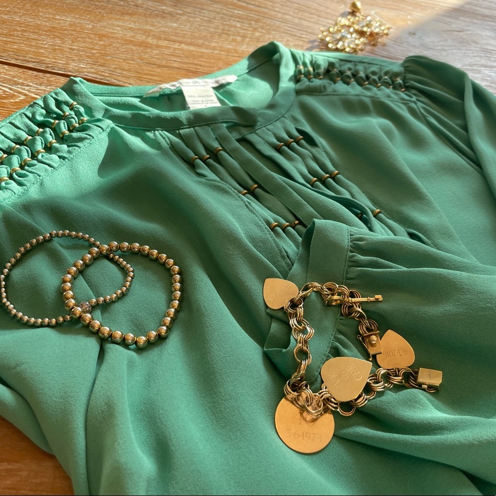 Elegant DVF long sleeved jade blouse with gold details. Size 4.